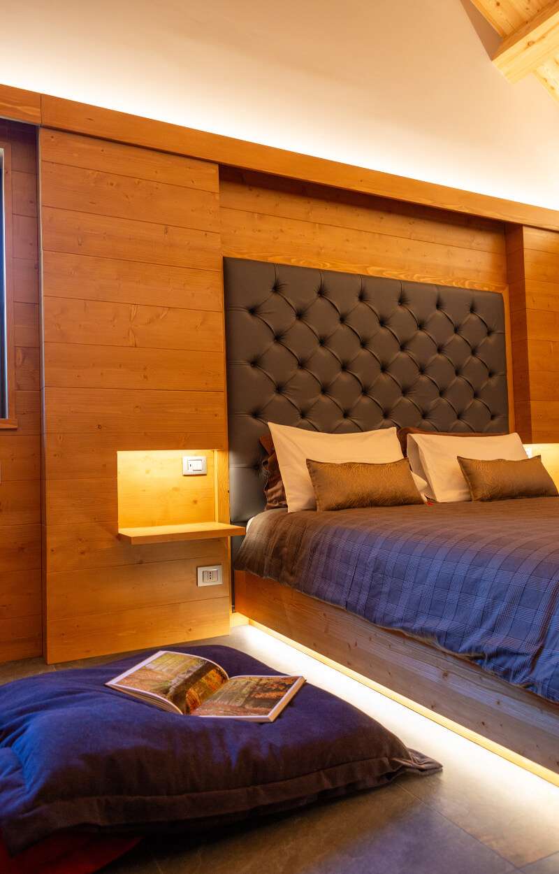 Camera matrimoniale con area lettura libri dello Chalet Cima di terra rossa al Kile Alpine Resort a Valbruna in Val Saisera 